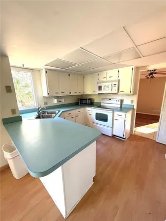 a kitchen with stainless steel appliances granite countertop a sink and a stove