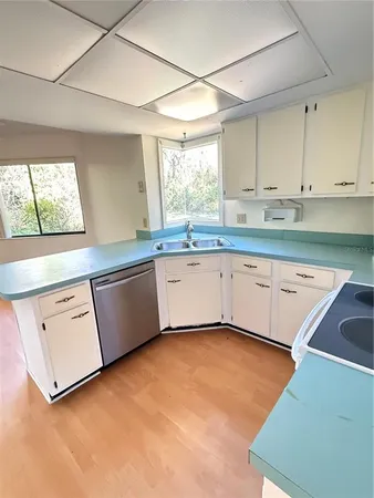 a kitchen with granite countertop white cabinets and white appliances