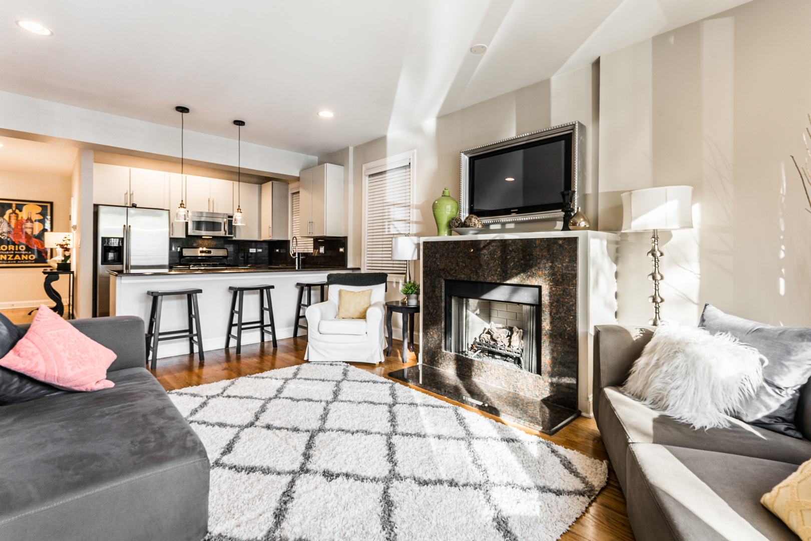 844 West Erie Street, Unit 1 Chicago, IL 60642 - Photo 2 of 37 a living room with stainless steel appliances furniture a fireplace a flat screen tv and view kitchen