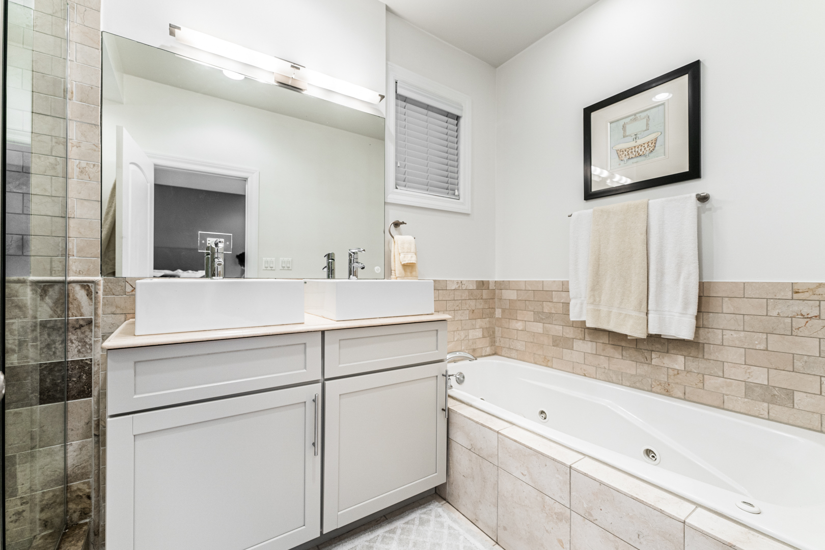 844 West Erie Street, Unit 1 Chicago, IL 60642 - Photo 19 of 37 a bathroom with a bathtub sink and mirror
