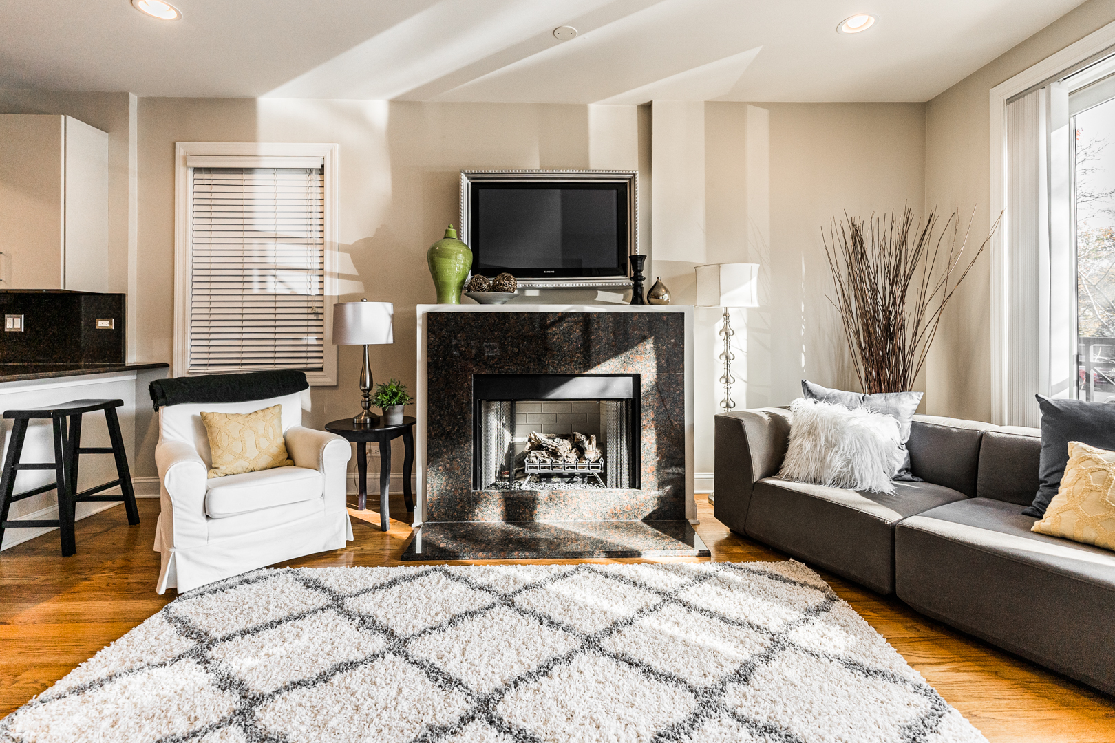 844 West Erie Street, Unit 1 Chicago, IL 60642 - Photo 4 of 37 a living room with furniture a flat screen tv and a fireplace
