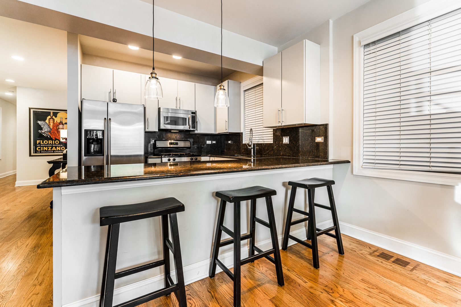 844 West Erie Street, Unit 1 Chicago, IL 60642 - Photo 7 of 37 a kitchen with stainless steel appliances granite countertop a table chairs sink and cabinets