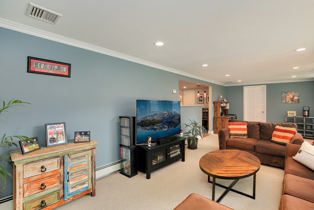 4 Beaconsfield Drive Natick, MA 01760 - Photo 13 of 22 a living room with furniture and a flat screen tv