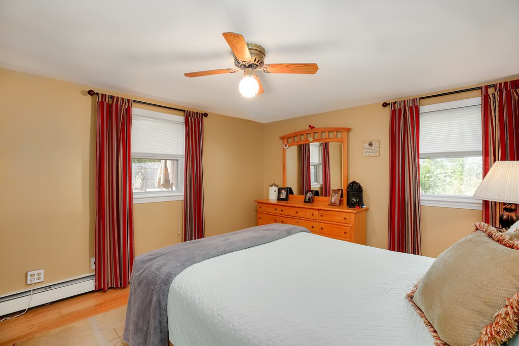 4 Beaconsfield Drive Natick, MA 01760 - Photo 15 of 22 a bedroom with a bed and wooden floor