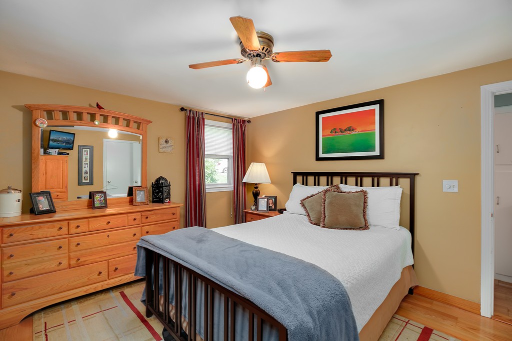 4 Beaconsfield Drive Natick, MA 01760 - Photo 16 of 22 a bedroom with a large bed and a chandelier
