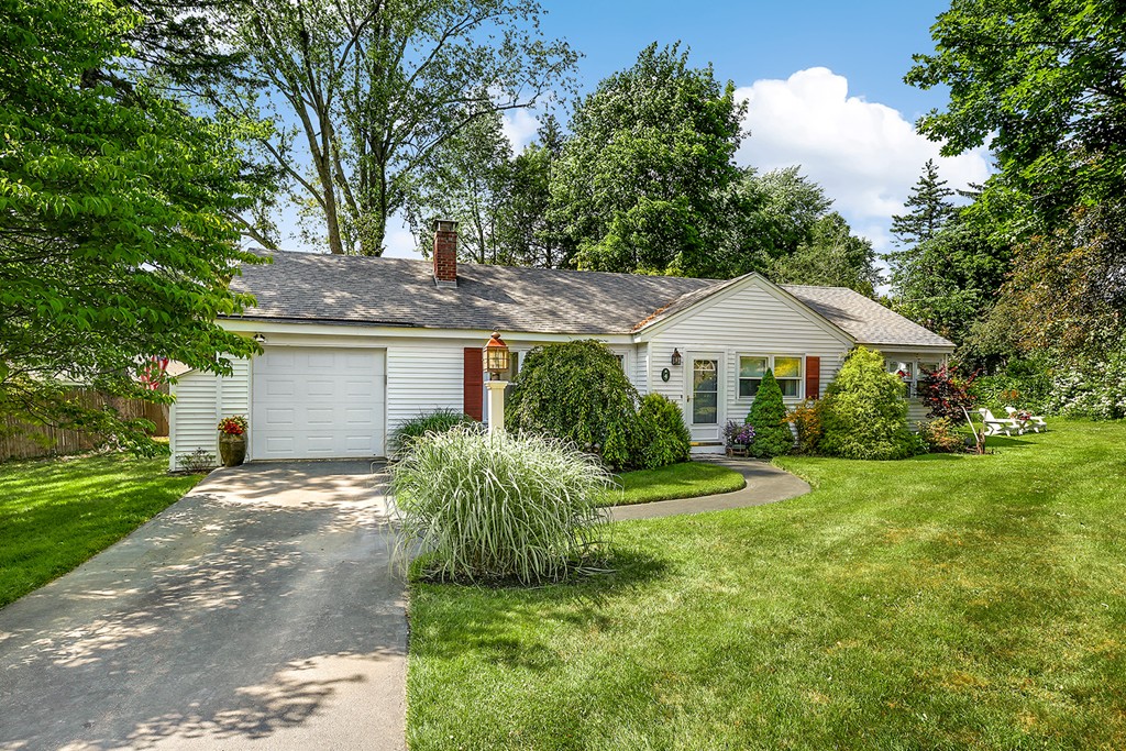 4 Beaconsfield Drive Natick, MA 01760 - Photo 2 of 22 a front view of a house with a yard and garage