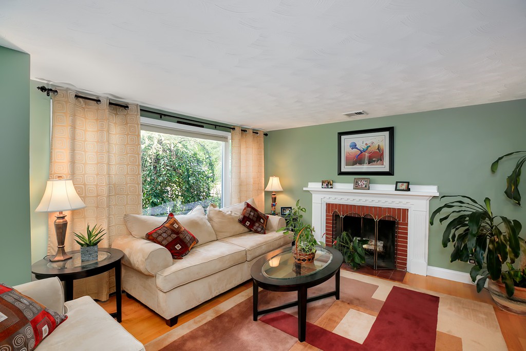 4 Beaconsfield Drive Natick, MA 01760 - Photo 3 of 22 a living room with furniture a large window and a fireplace