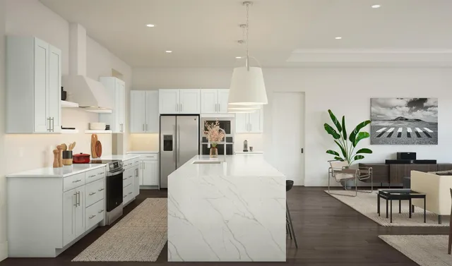 a large white kitchen with cabinets stove and refrigerator
