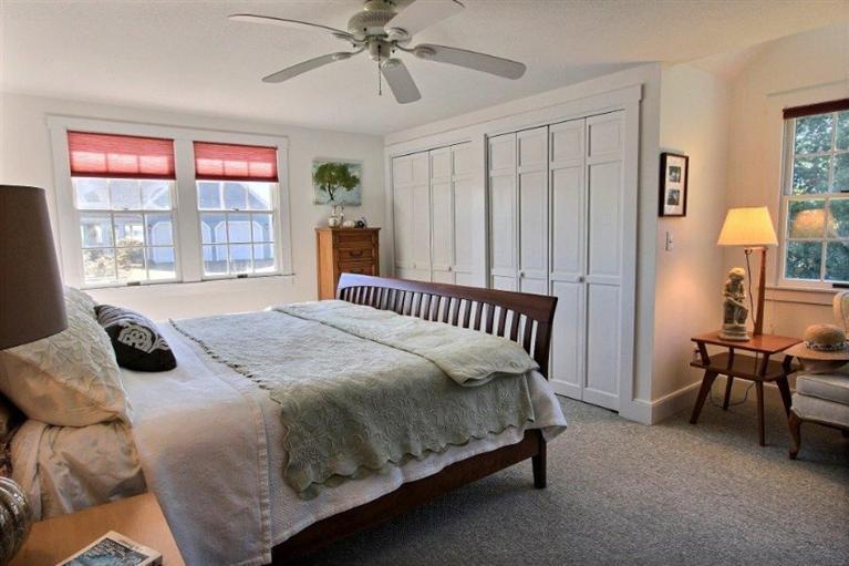 149 Leeward Road Bourne, MA 02532 - Photo 11 of 35 a bedroom with a bed a table and large window