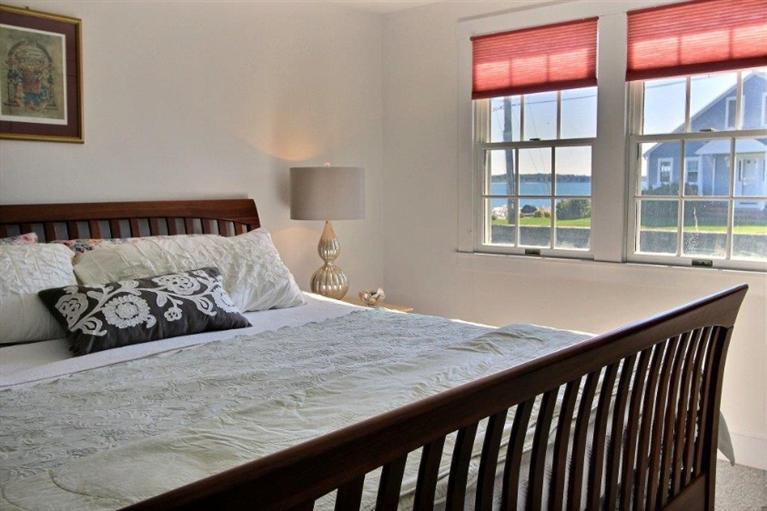 149 Leeward Road Bourne, MA 02532 - Photo 12 of 35 a bed sitting in a bedroom next to a window