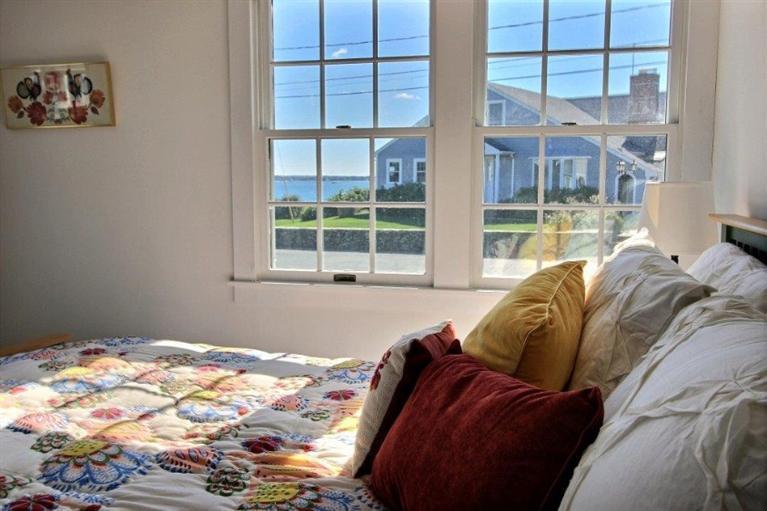 149 Leeward Road Bourne, MA 02532 - Photo 16 of 35 a bed sitting in a bedroom next to a window