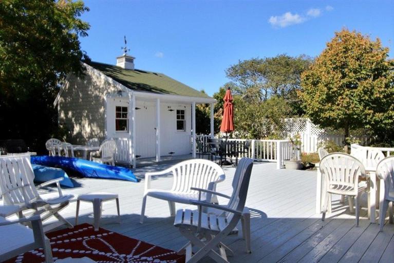 149 Leeward Road Bourne, MA 02532 - Photo 21 of 35 a view of a patio with furniture and a yard