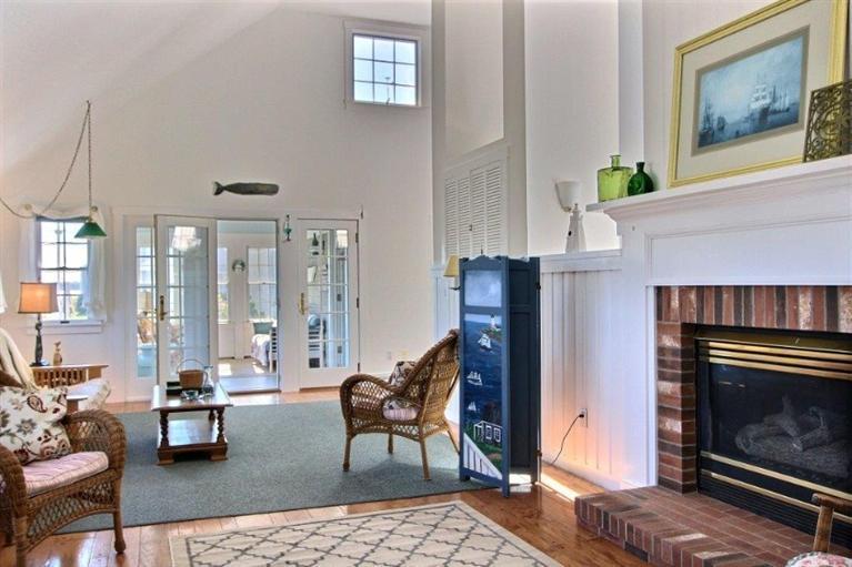 149 Leeward Road Bourne, MA 02532 - Photo 4 of 35 a living room with furniture a large window and a fireplace