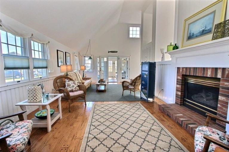 149 Leeward Road Bourne, MA 02532 - Photo 5 of 35 a living room with furniture large window and a fireplace