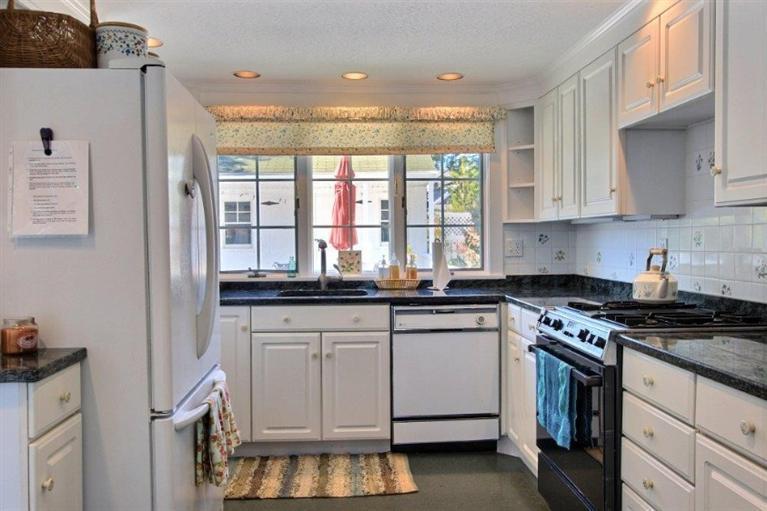 149 Leeward Road Bourne, MA 02532 - Photo 7 of 35 a kitchen with granite countertop white cabinets and white appliances