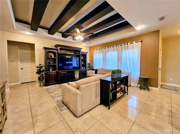 a kitchen with stainless steel appliances kitchen island granite countertop a barbecue grill and a view of living room