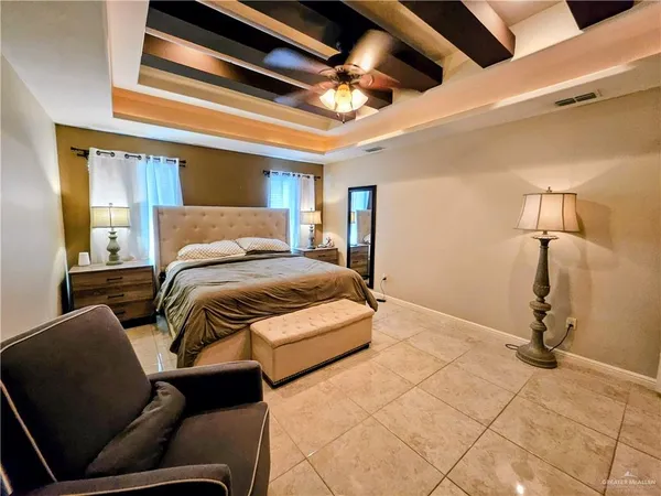 a bedroom with a bed couch and a ceiling fan