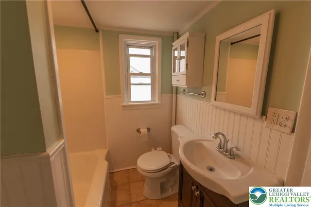 a view of a room with wooden floor and window