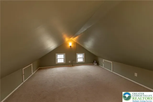 a view of a porch with furniture and floor to ceiling window