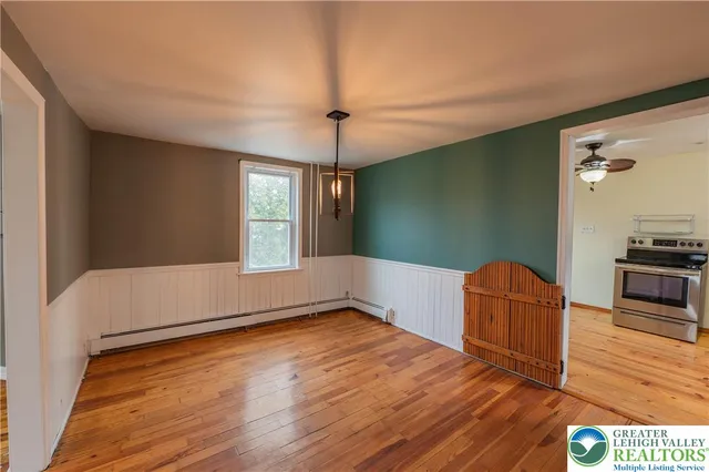 a living room with hard wood floors and a ceiling fan