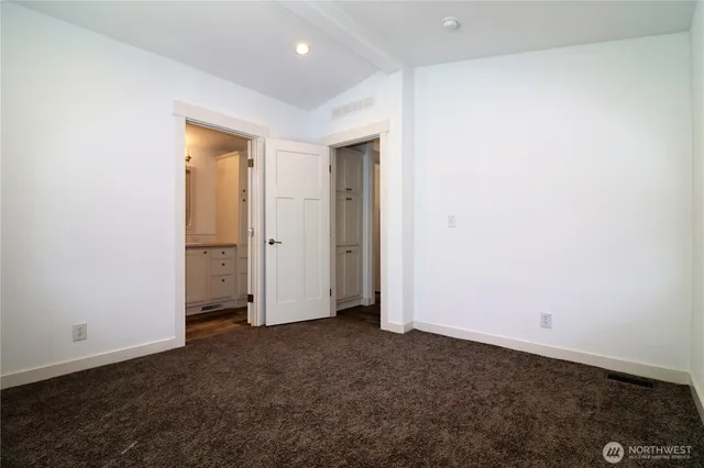 an empty room with closet area