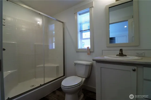 a bathroom with a sink toilet and shower