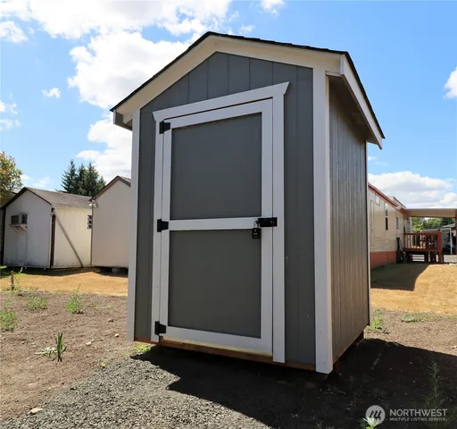 a view of a house with a wooden fence