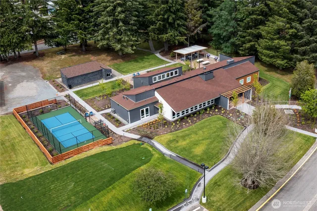 an aerial view of residential house with outdoor space and swimming pool