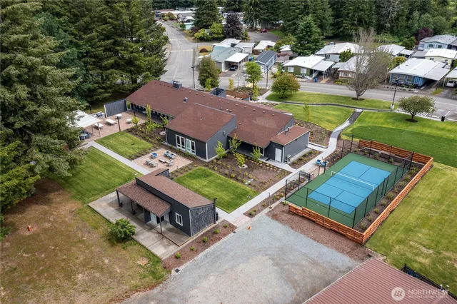 an aerial view of a house with a garden and lake view