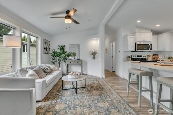 a living room with furniture and kitchen view