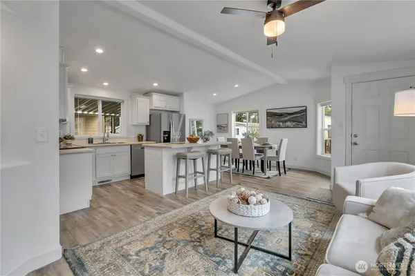 a kitchen with stainless steel appliances granite countertop a refrigerator and a stove top oven