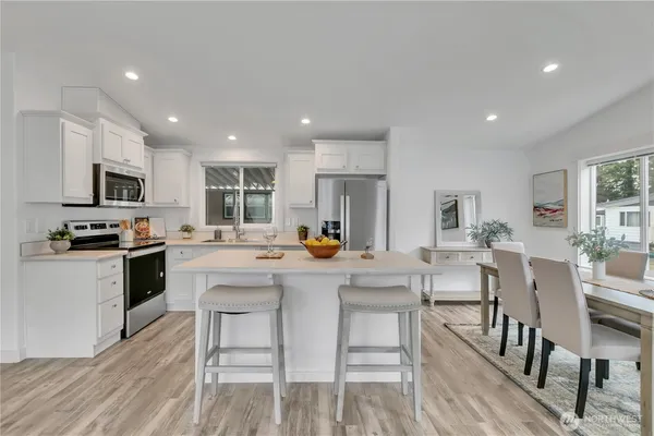 a kitchen with a refrigerator and a sink