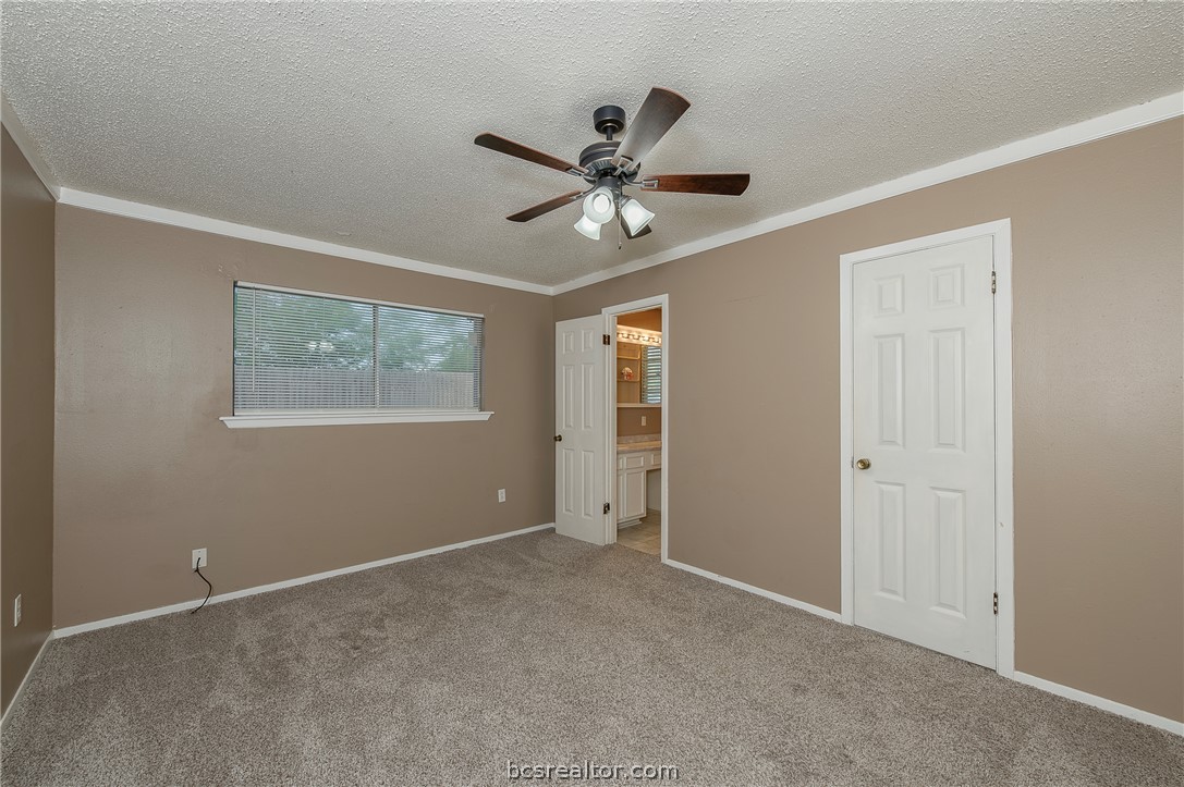2303 Avon Street Bryan, TX 77802 - Photo 11 of 32 Spacious bedroom with access to primary bath room with tile shower & walk-in closet