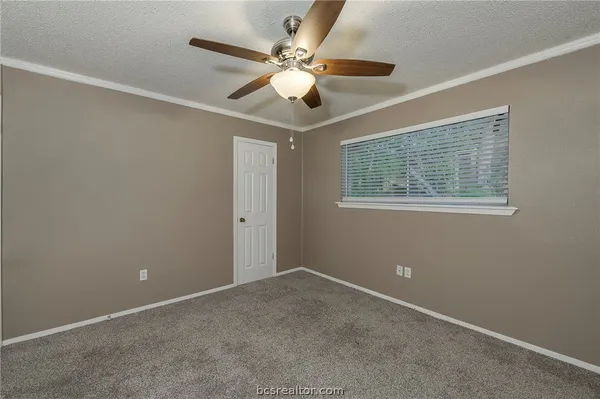 a view of an empty room with a ceiling fan