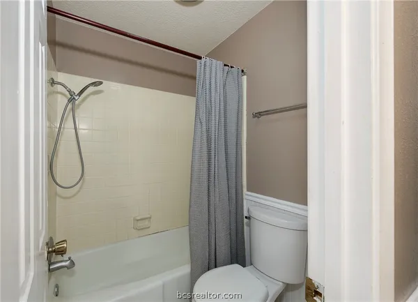 a bathroom with a shower and a toilet