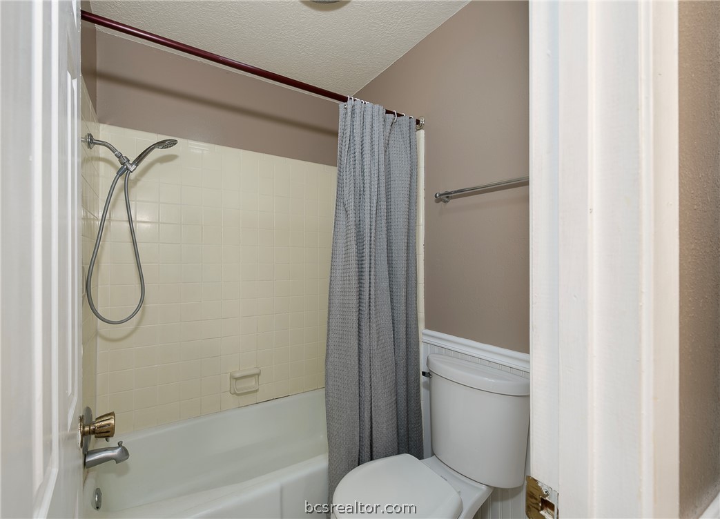2303 Avon Street Bryan, TX 77802 - Photo 16 of 32 Tile bath/shower combo in guest bathroom