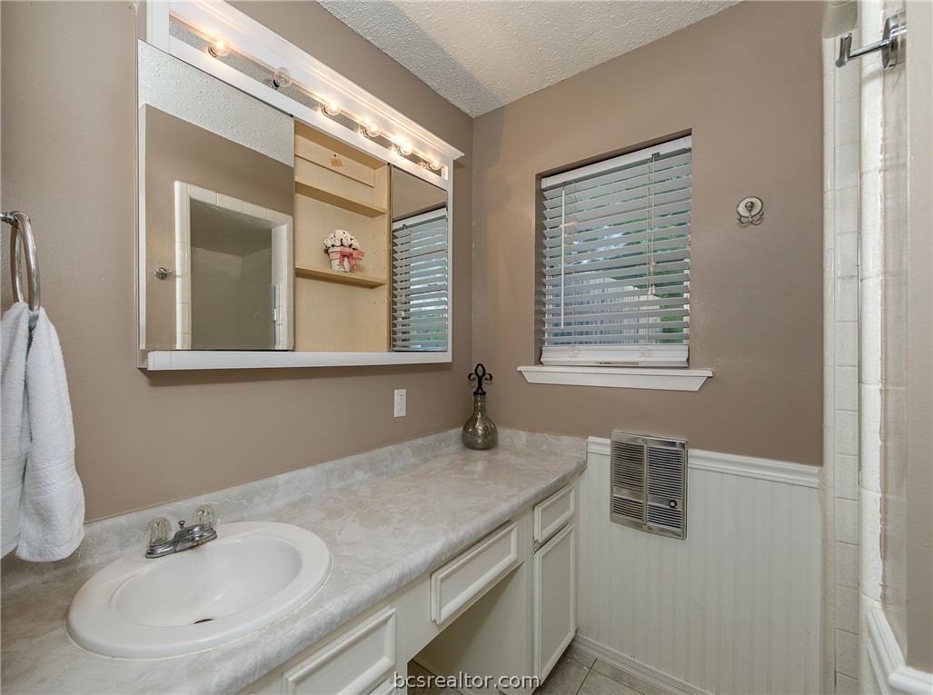 2303 Avon Street Bryan, TX 77802 - Photo 17 of 32 Primary Bathroom view of mirrored storage & plenty of cabinet counter tops.