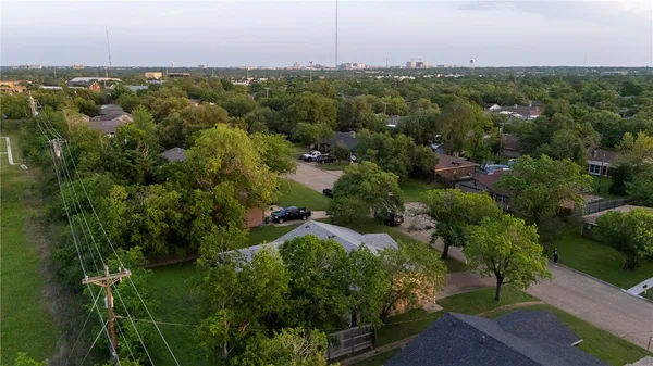 an aerial view of a houses with a yard