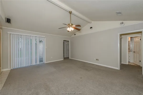 a view of an empty room with a ceiling fan