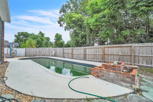 a view of a swimming pool in a backyard
