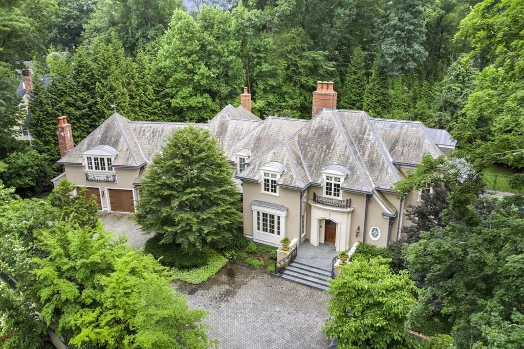 a aerial view of a house with a yard plants and large tree