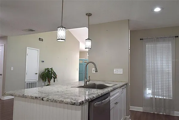 a kitchen with a granite countertop sink and a granite counter tops