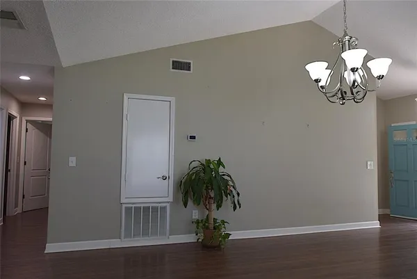 a view of a room with wooden floor