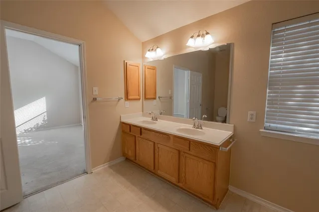 a kitchen with stainless steel appliances granite countertop a refrigerator a sink a stove and a wooden floors