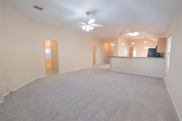 a view of a kitchen with a sink and a chandelier fan