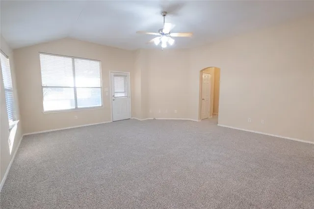 a view of a livingroom with a ceiling fan and window