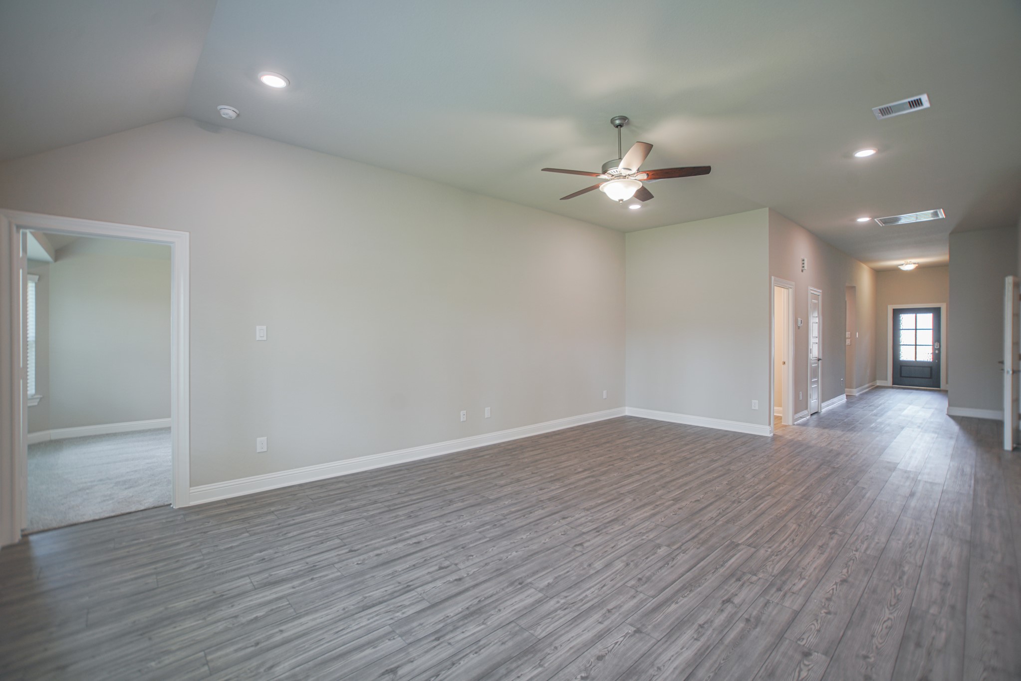 17112 Coneflower Place Conroe, TX 77385 - Photo 8 of 27 wooden floor in an empty room with a window
