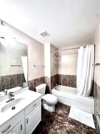 a bathroom with a double vanity sink toilet and shower