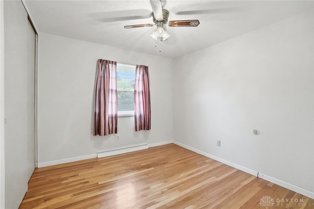 877 Woodhill Road Riverside, OH 45431 - Photo 21 of 42 This airy bedroom offers comfortable living with warm wood floors and ample natural light.