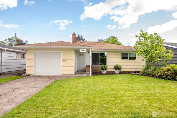 a view of a house with a yard and sitting area